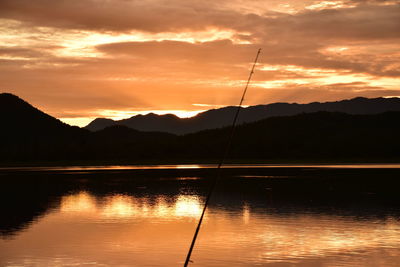 Scenic view of lake against romantic sky at sunset