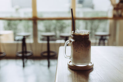 Iced coffee in jar on table at restaurant