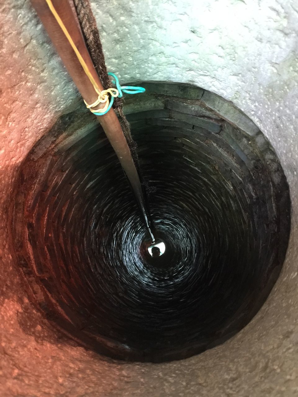 high angle view, water, motion, close-up, one person, outdoors, wood - material, reflection, circle, tunnel, day, part of, textured, one animal, metal, spinning, rippled, waterfront