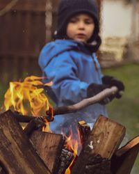 Boy burning wood