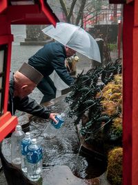 Midsection of woman working in water