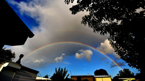 Low angle view of rainbow over building