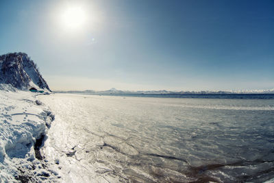 Scenic view of frozen lake against sky during winter