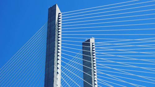 Low angle view of modern building against clear blue sky