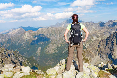 Rear view of woman standing on mountain