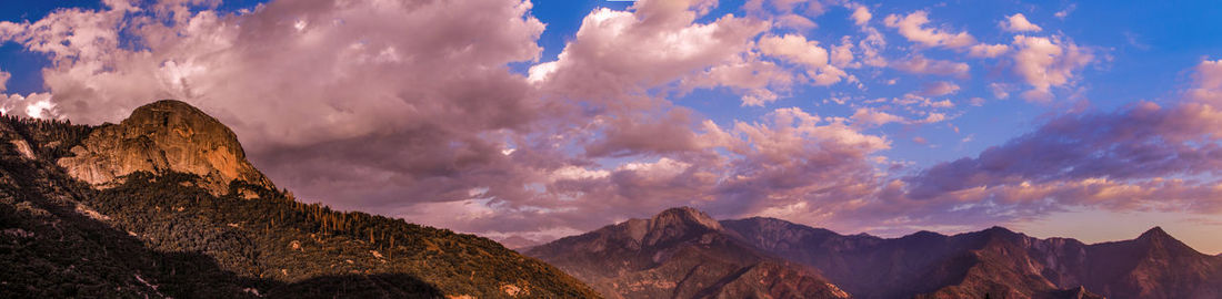 Panoramic view of mountains against cloudy sky