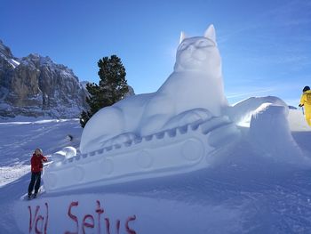 Person on snowcapped mountain against sky