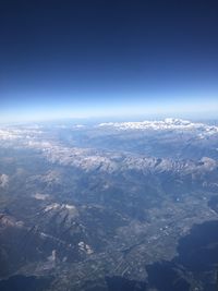 Aerial view of dramatic landscape against blue sky