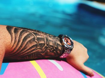 Low section of woman with legs in swimming pool