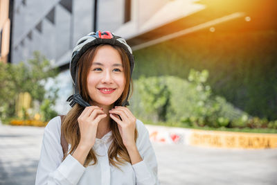 Portrait of smiling young woman standing outdoors