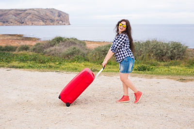 Full length of young woman on beach