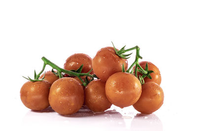 Close-up of tomatoes against white background