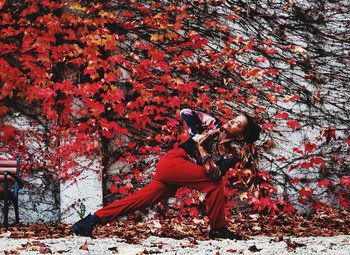 Woman with red leaves during autumn