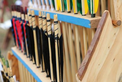 Close-up of multi colored traditional archery arrows in store