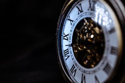 Close-up of clock against black background