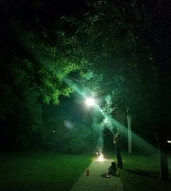 Man walking on road at night