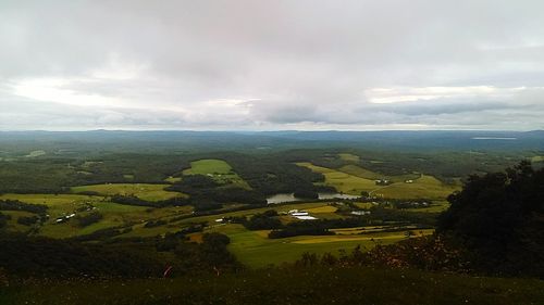 Scenic view of landscape against cloudy sky