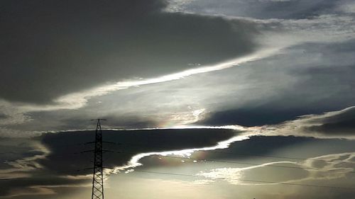 Low angle view of electricity pylon against sky