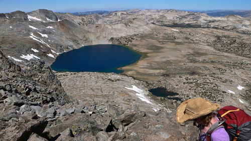 Man standing on rock by mountain