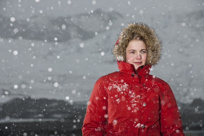 Young woman walking through snowstorm in iceland