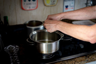 Onions being placed in the pan. food seasoning.