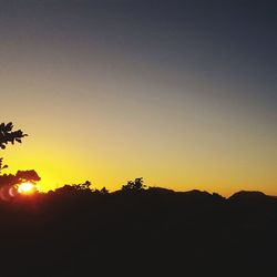 Low angle view of silhouette trees against sky during sunset