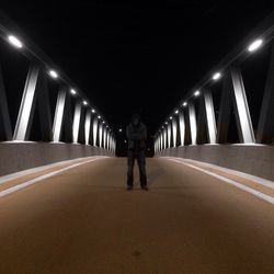 Rear view of woman walking in tunnel