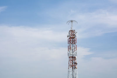 Low angle view of communications tower against sky