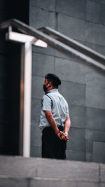 Full length of man standing against building