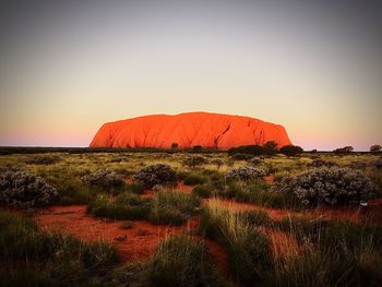 Scenic view of land against sky during sunset