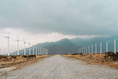 Road by mountain against sky