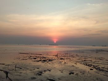 Scenic view of beach against sky during sunset