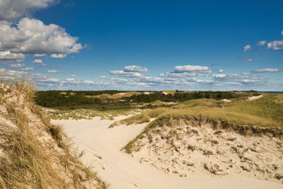 Scenic view of beach against blue sky