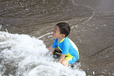 High angle view of boy playing in the beach