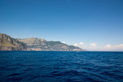 Scenic view of sea against blue sky