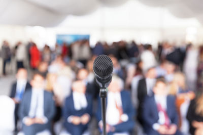 Close-up of microphone against audience