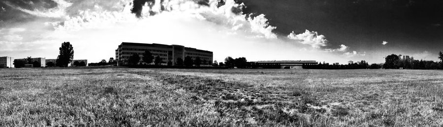 Built structure on field against cloudy sky