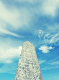 Low angle view of building against cloudy sky