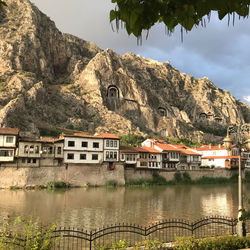 Lake by buildings against sky