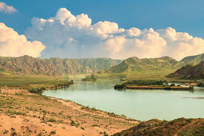 Scenic view of lake and mountains against sky