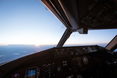 Airplane window against sky