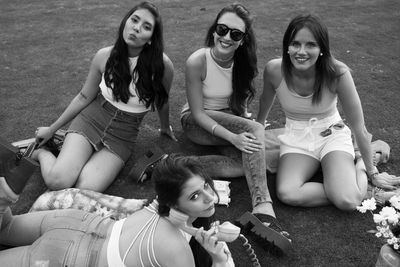 High angle portrait of friends relaxing on land in park