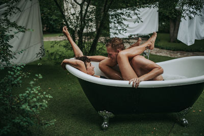 Couple in bathtub outdoors