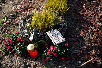 High angle view of cross and flowers at cemetery