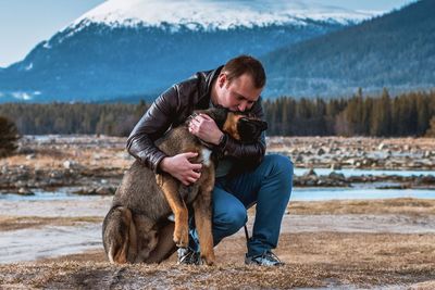 Full length of woman with dog during winter