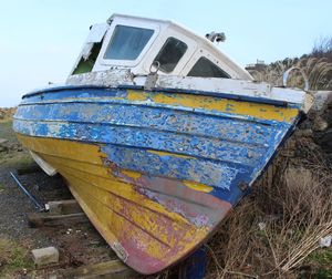 Close-up of abandoned boat on shore