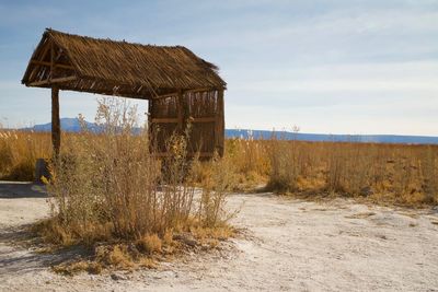 Abandoned house on field against sky