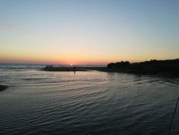 Scenic view of sea against clear sky during sunset