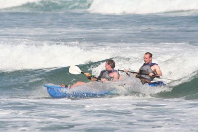 Men boating on sea