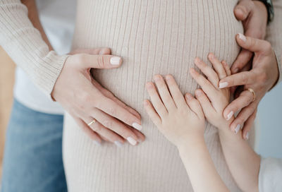 Midsection of couple holding hands